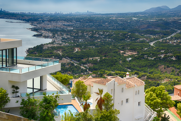 What are the advantages of buying a new villa with a pool in Spain versus a resale property?